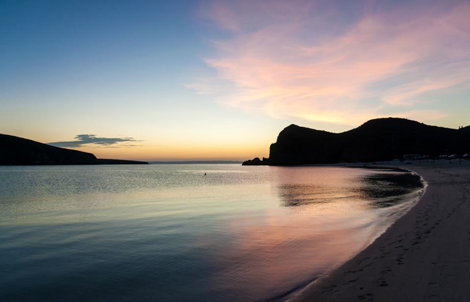 Lone figure on Baja California salt flat at blue hour